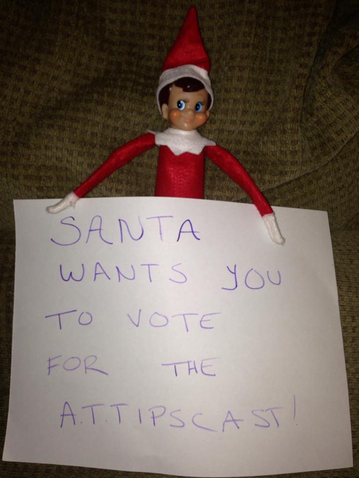 Elf on the Shelf holding a sign that reads "Santa wants you to vote for the A.T.TIPSCAST"